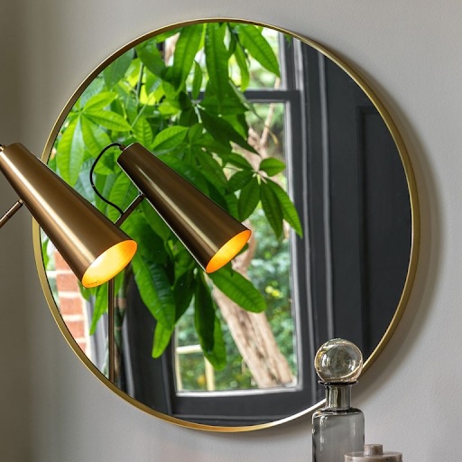 mirror that makes a statement, large black mirror, large round mirror, Every home needs a mirror that makes a statement, make a bold statement, enhance natural lighting, vintage décor, well-placed mirror, double as artwork, contrast and depth, bounce light around a room, dark corners feel brighter, placing a mirror opposite a window, reflect natural light, understated elegance, frame of a mirror, statement mirror